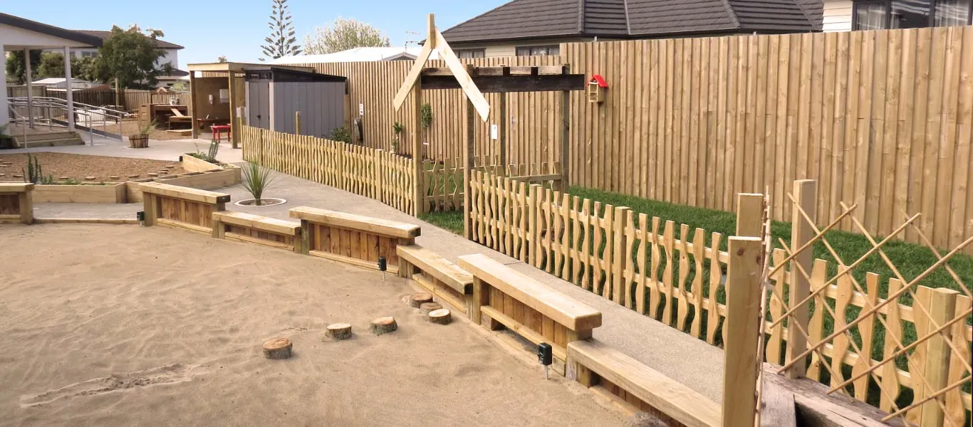 The large sandpit and garden area at Children's Ark with timber seating