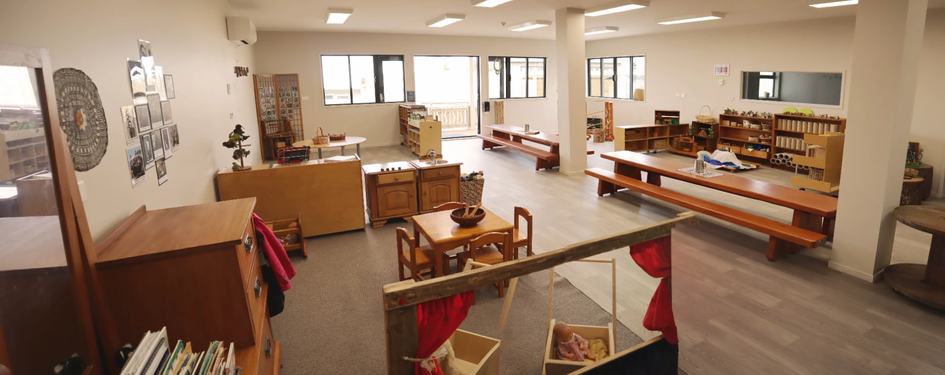 The Kākāpō Room for three to five year olds with tables, literacy displays and open shelving